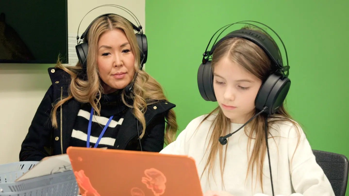 Adult working with student in EdTech environment